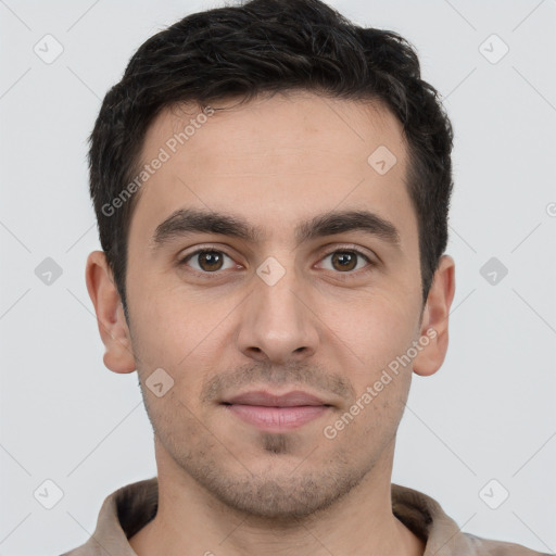 Joyful white young-adult male with short  brown hair and brown eyes