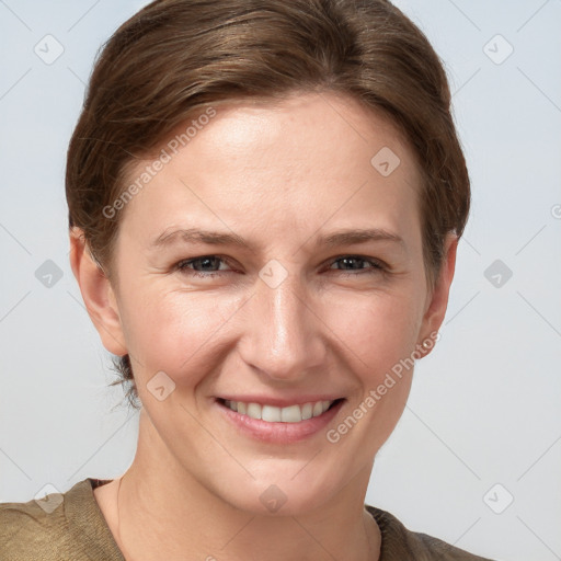 Joyful white young-adult female with short  brown hair and grey eyes