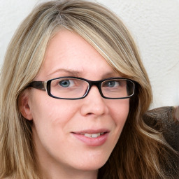 Joyful white adult female with long  brown hair and blue eyes