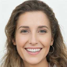 Joyful white young-adult female with long  brown hair and green eyes