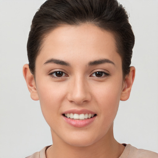 Joyful white young-adult female with short  brown hair and brown eyes