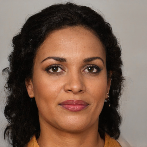 Joyful black young-adult female with medium  brown hair and brown eyes