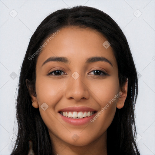 Joyful latino young-adult female with long  black hair and brown eyes