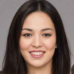 Joyful asian young-adult female with long  brown hair and brown eyes