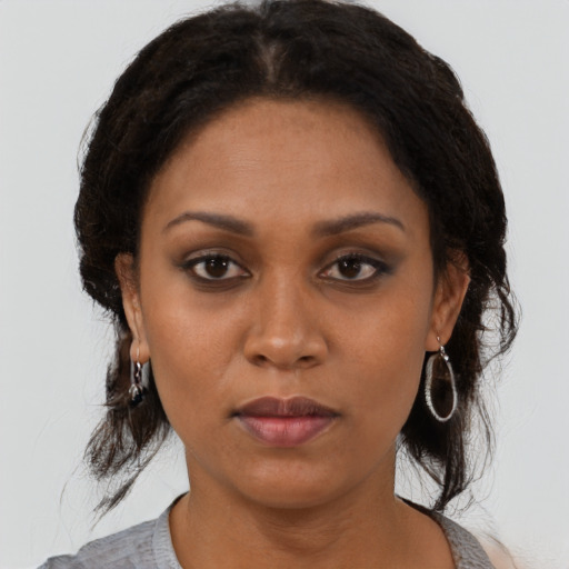 Neutral black young-adult female with medium  brown hair and brown eyes
