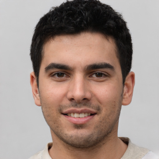 Joyful white young-adult male with short  black hair and brown eyes