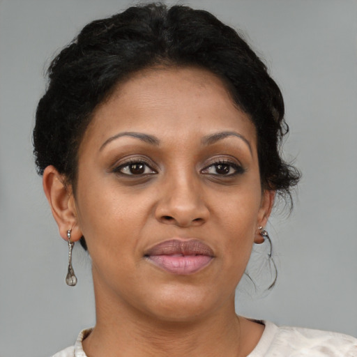 Joyful black adult female with short  brown hair and brown eyes
