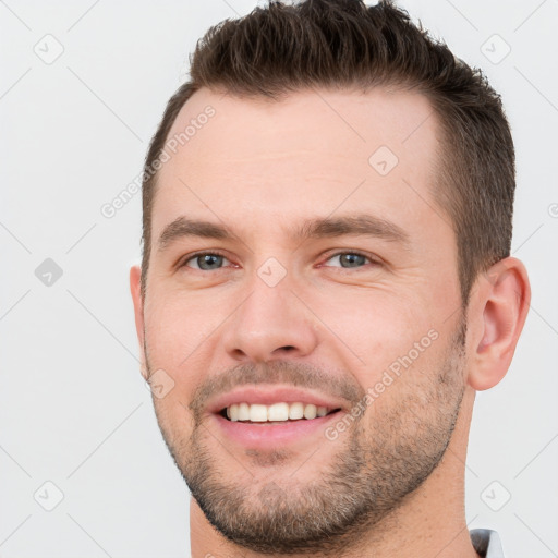 Joyful white young-adult male with short  brown hair and brown eyes