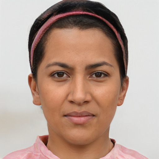 Joyful latino young-adult female with short  brown hair and brown eyes