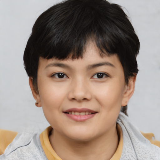 Joyful white child female with short  black hair and brown eyes