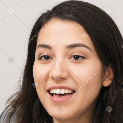 Joyful white young-adult female with long  black hair and brown eyes