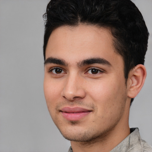 Joyful white young-adult male with short  black hair and brown eyes
