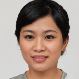 Joyful asian young-adult female with medium  black hair and brown eyes