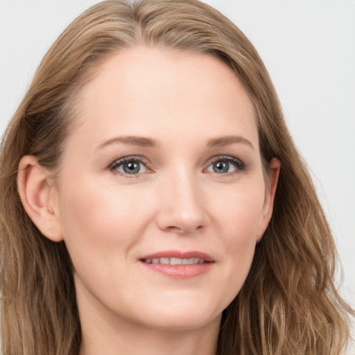 Joyful white young-adult female with long  brown hair and blue eyes