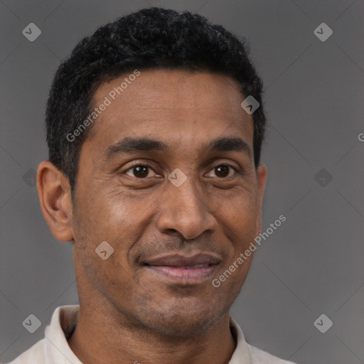 Joyful latino adult male with short  brown hair and brown eyes