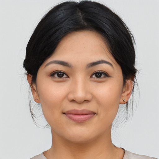Joyful asian young-adult female with medium  black hair and brown eyes