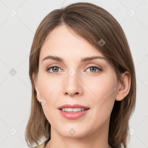 Joyful white young-adult female with medium  brown hair and grey eyes