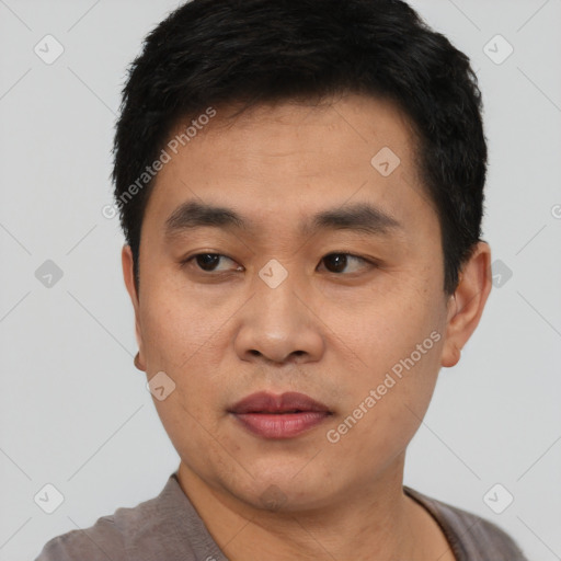 Joyful asian young-adult male with short  black hair and brown eyes