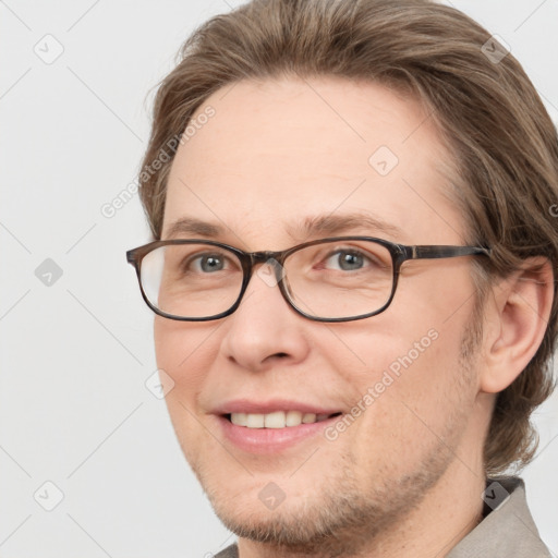 Joyful white adult male with short  brown hair and brown eyes