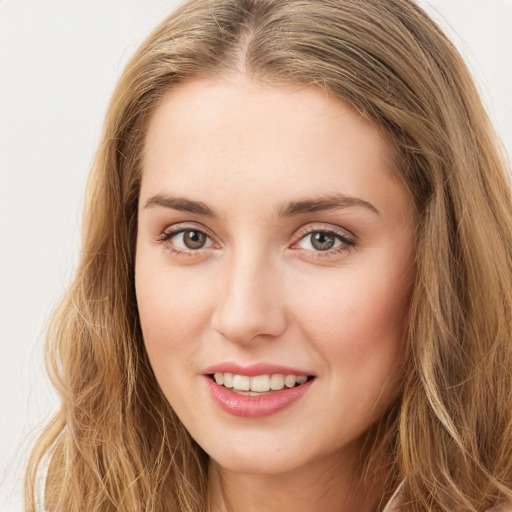 Joyful white young-adult female with long  brown hair and green eyes