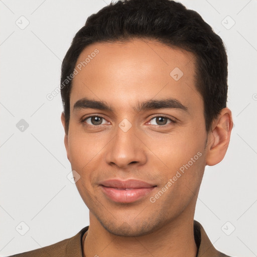 Joyful latino young-adult male with short  black hair and brown eyes