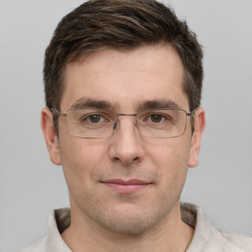 Joyful white adult male with short  brown hair and grey eyes