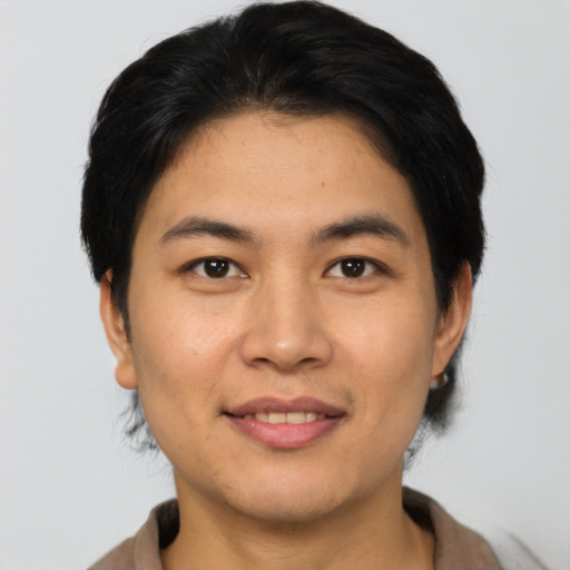 Joyful asian young-adult male with short  brown hair and brown eyes