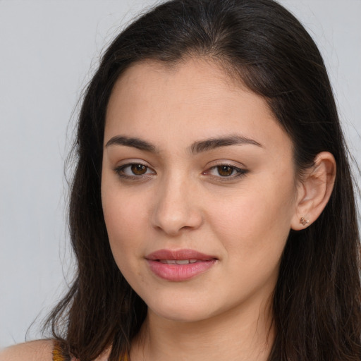 Joyful white young-adult female with long  brown hair and brown eyes