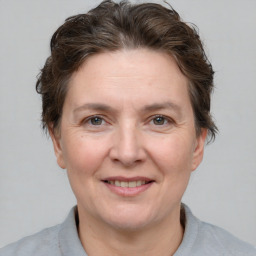 Joyful white adult female with short  brown hair and brown eyes