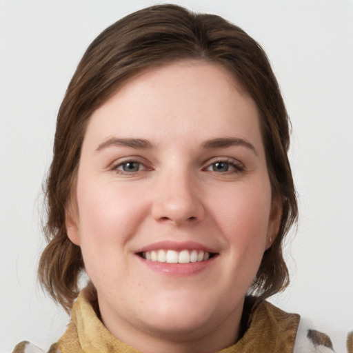 Joyful white young-adult female with medium  brown hair and blue eyes