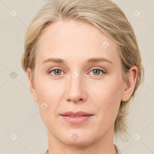 Joyful white young-adult female with medium  brown hair and blue eyes