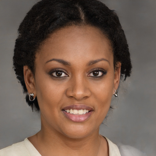 Joyful black young-adult female with short  brown hair and brown eyes
