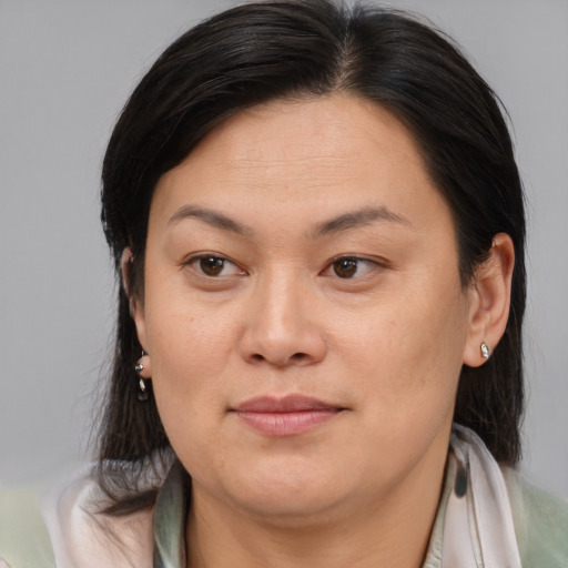 Joyful asian adult female with medium  brown hair and brown eyes