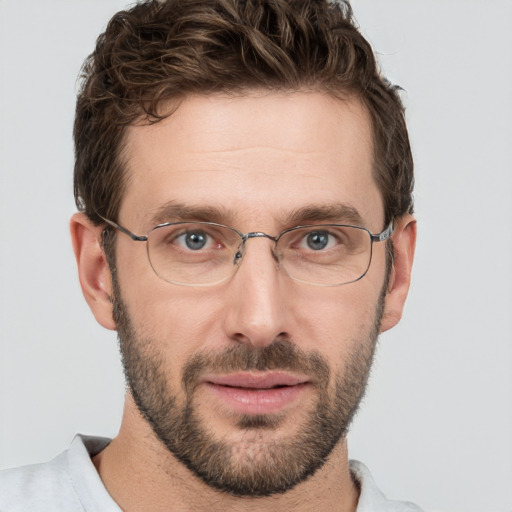 Joyful white adult male with short  brown hair and grey eyes