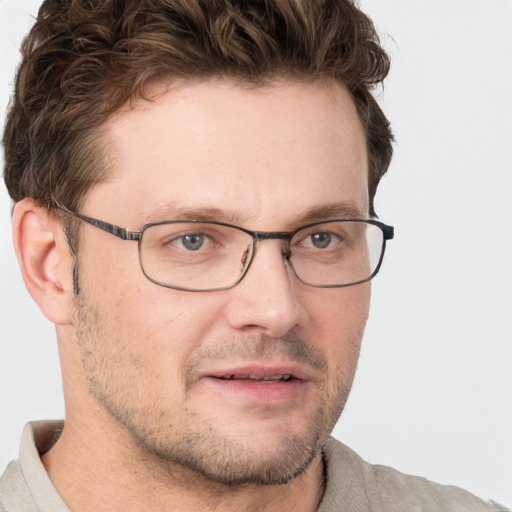 Joyful white adult male with short  brown hair and grey eyes