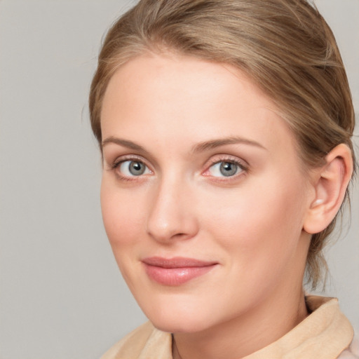 Joyful white young-adult female with medium  brown hair and blue eyes