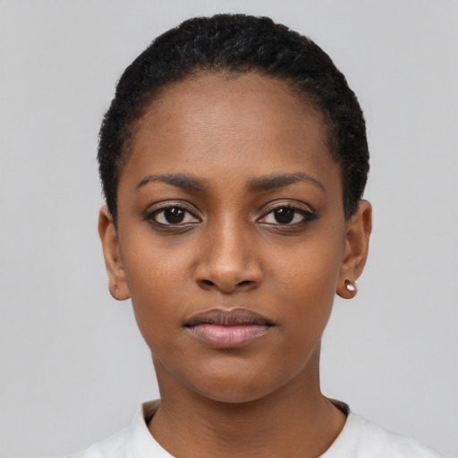 Joyful black young-adult female with short  black hair and brown eyes