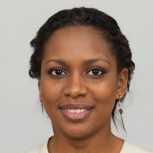 Joyful black young-adult female with short  brown hair and brown eyes