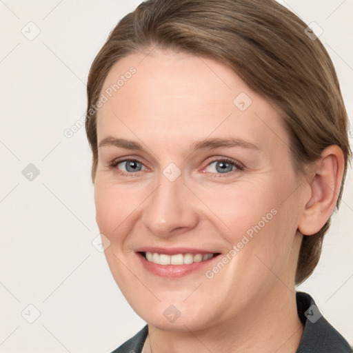 Joyful white young-adult female with medium  brown hair and blue eyes