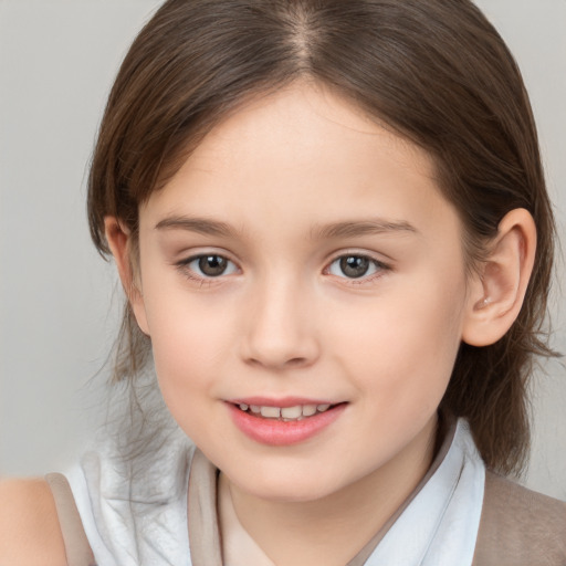 Joyful white child female with medium  brown hair and brown eyes