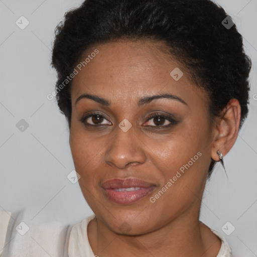 Joyful black young-adult female with short  brown hair and brown eyes