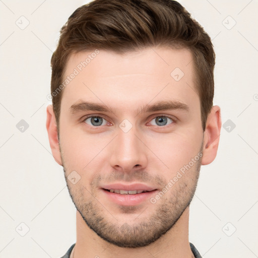 Joyful white young-adult male with short  brown hair and grey eyes