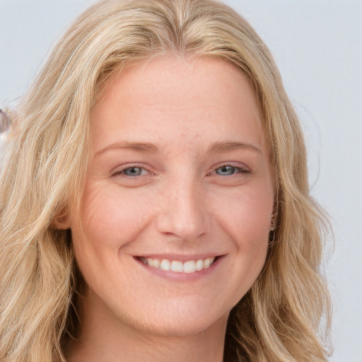 Joyful white young-adult female with long  blond hair and blue eyes