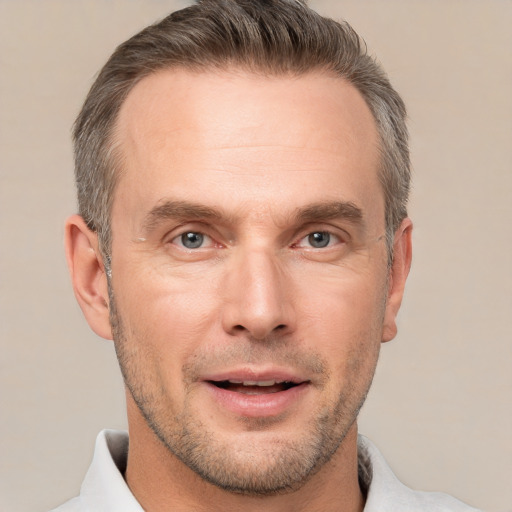 Joyful white adult male with short  brown hair and brown eyes