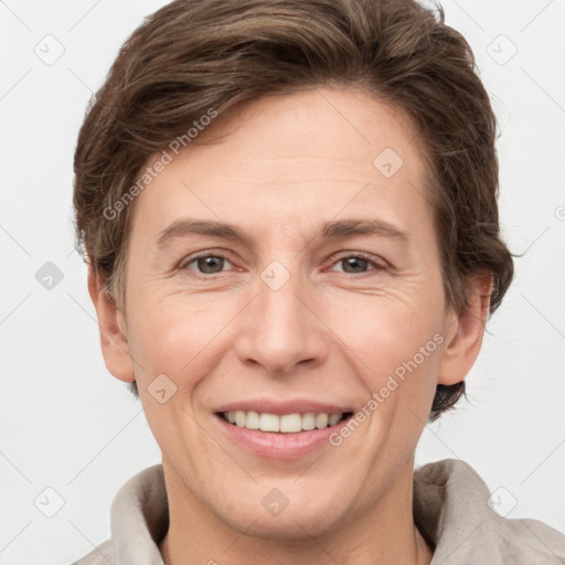 Joyful white adult female with short  brown hair and grey eyes