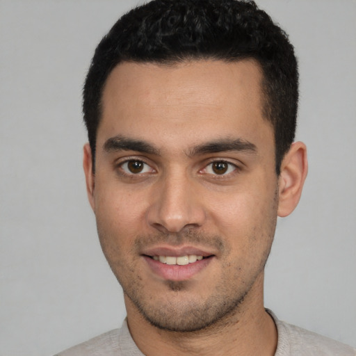 Joyful white young-adult male with short  black hair and brown eyes