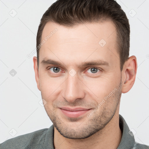 Joyful white young-adult male with short  brown hair and brown eyes