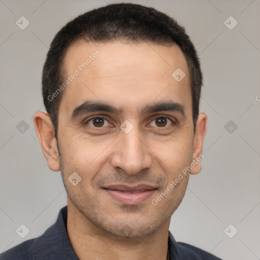 Joyful white young-adult male with short  black hair and brown eyes