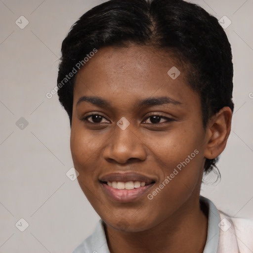 Joyful black young-adult female with short  black hair and brown eyes