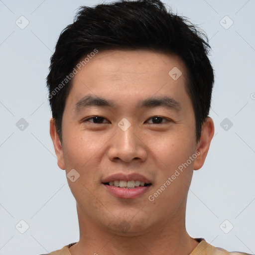 Joyful asian young-adult male with short  brown hair and brown eyes